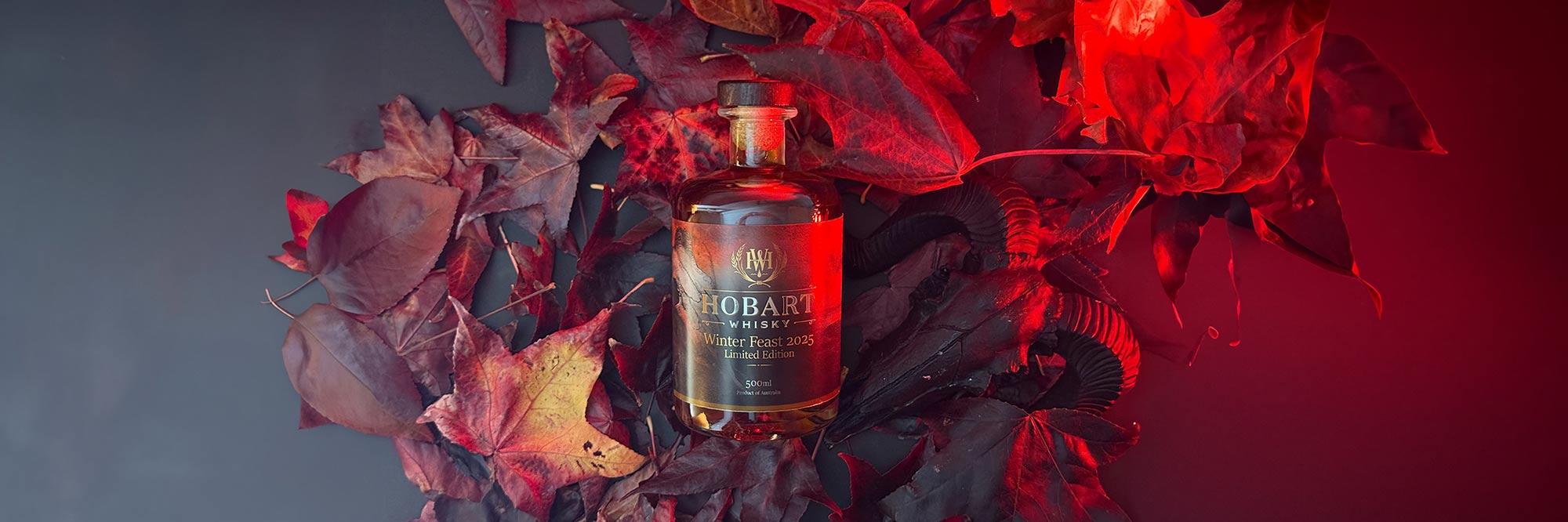 Hobart Whisky Label in lifestyle photo with leaves and moody lighting in the background